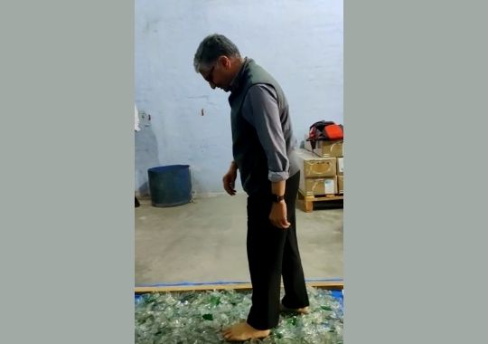 Trying to overcome the fear of mind by walking on pieces of glass